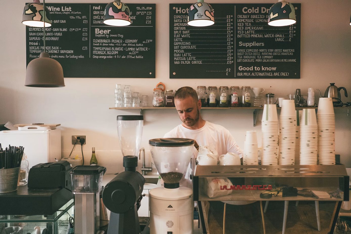 A café owner at work behind his counter